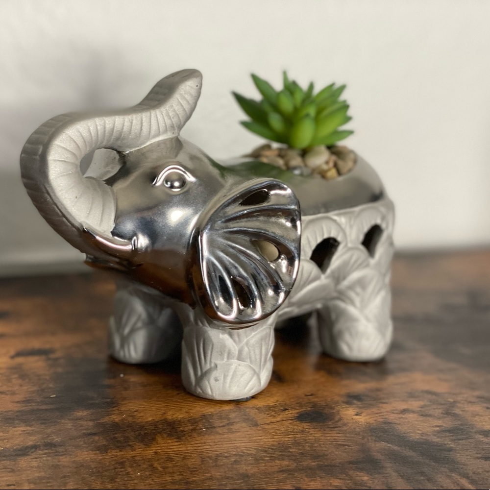 Decorative elephant with faux plant and rocks for table or desk top.